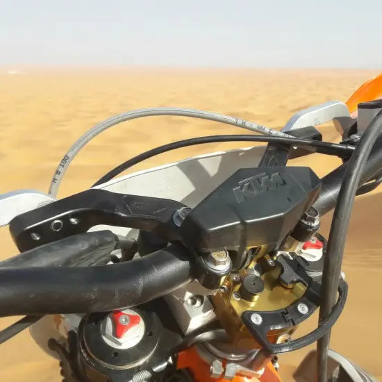 A motorcycle handlebar in the desert