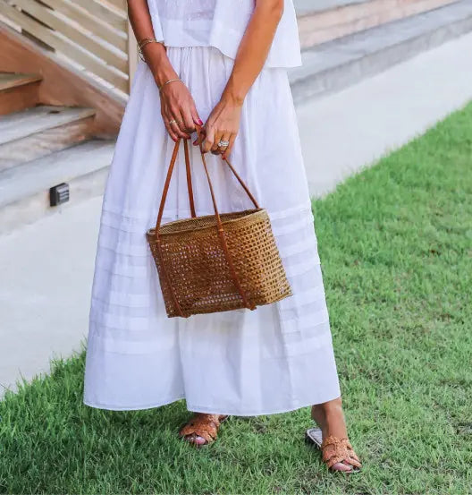 A woman holding a wicker bag.