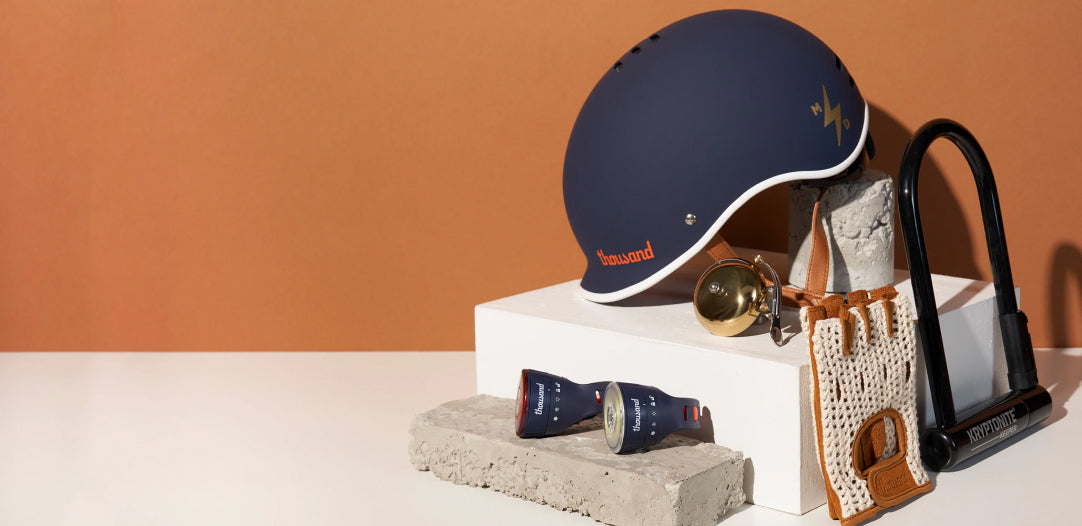 Bike helmet, lock, gloves, and other accessories curated in a studio setting